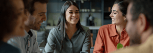 Five people smiling around a table